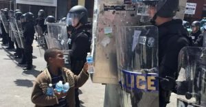 Kid Hands Out Water to Police